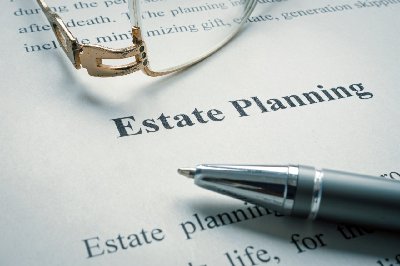Estate planning document with pen and glasses.
