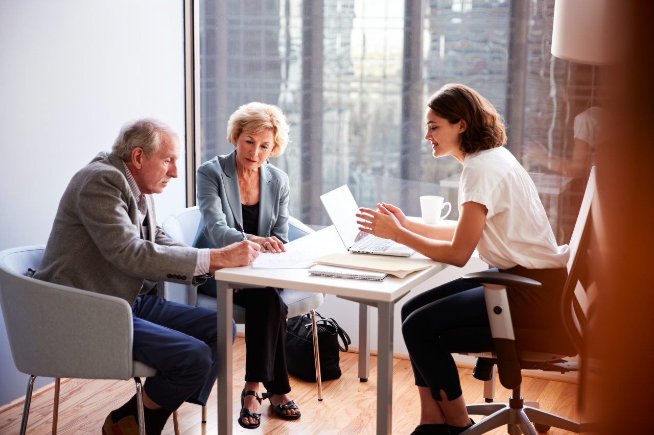 Three people having a business meeting.