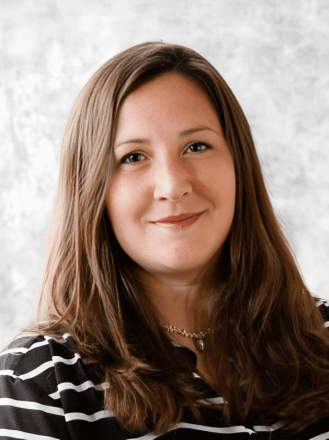 Smiling woman with long brown hair.