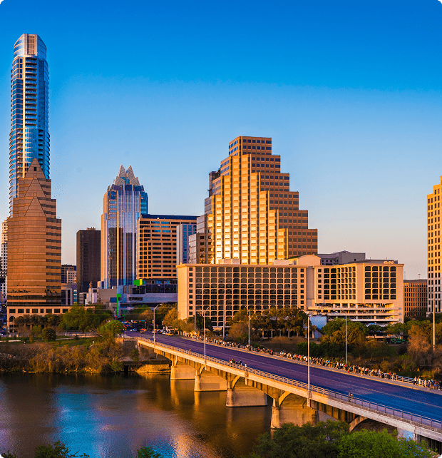 City skyline with bridge and river view.