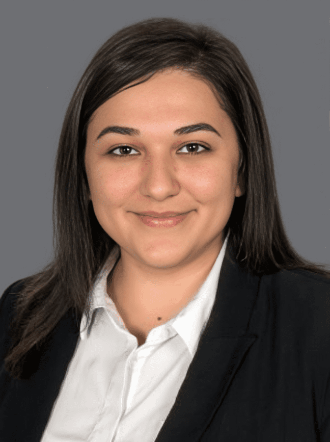 Smiling woman in professional attire portrait.