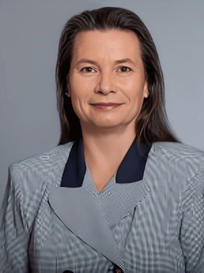 Woman in professional attire, smiling confidently.