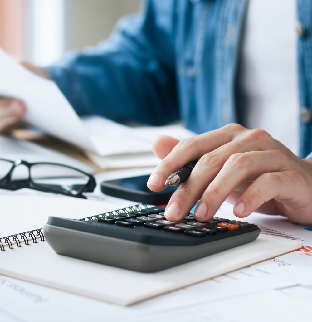Person using calculator at a desk.